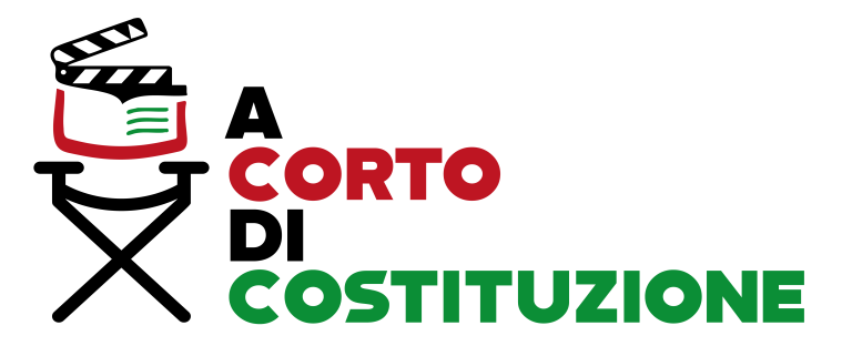 Logo tipografico “A corto di Costituzione” con la parola “CORTO” in rosso e “COSTITUZIONE” in verde su sfondo nero, accompagnato da un elemento grafico che richiama un libro aperto, a rappresentare il legame tra cinema e educazione civica.